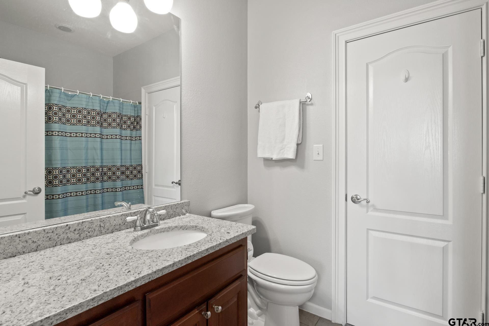 59 Private Road Pittsburg, TX 75686 - Photo 33 of 45 a bathroom with a granite countertop sink and a mirror