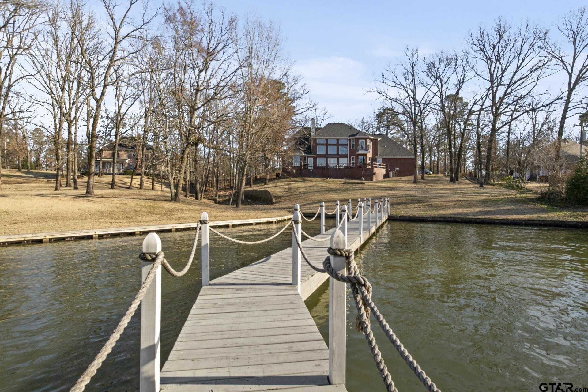 59 Private Road Pittsburg, TX 75686 - Photo 38 of 45 a view of a lake with trees in front of house