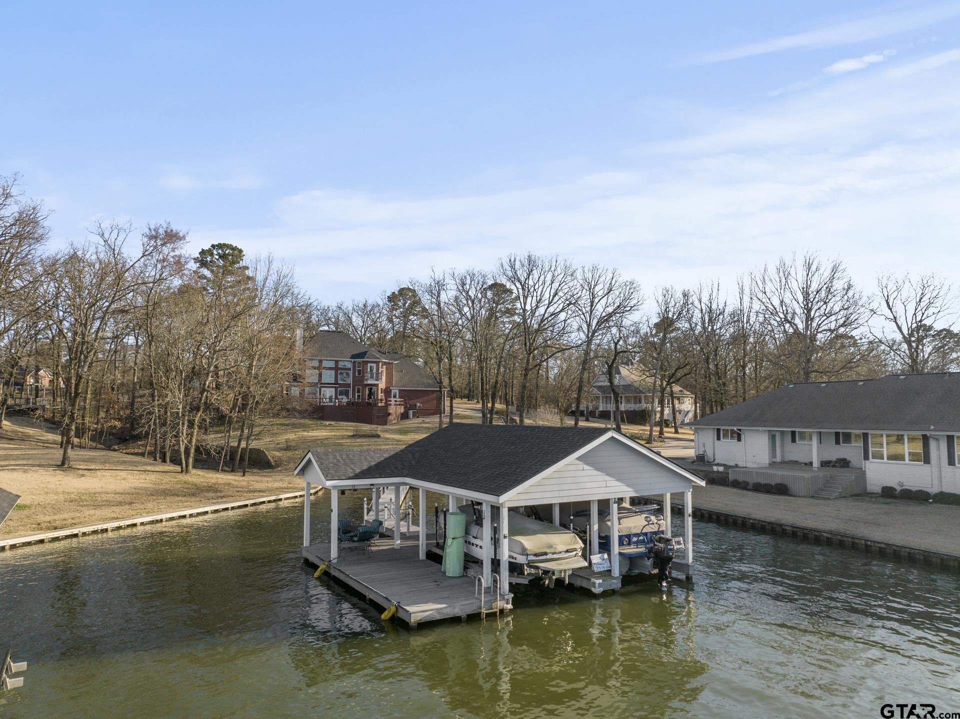 59 Private Road Pittsburg, TX 75686 - Photo 40 of 45 a aerial view of a house with swimming pool and lake view