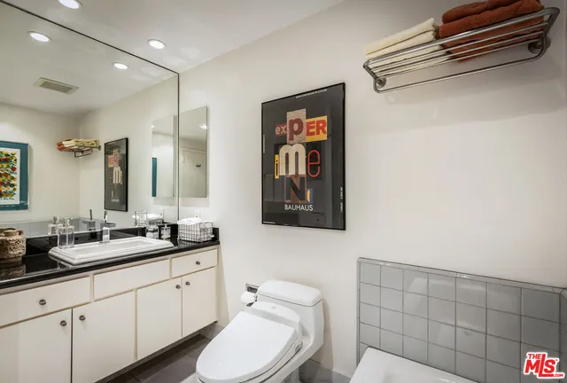 a bathroom with a double vanity sink mirror and shower