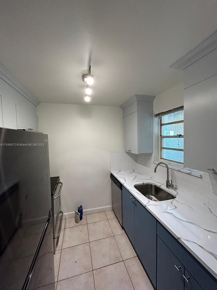 8550 Southwest 109th Avenue, Unit 5119 Miami, FL 33173 - Photo 12 of 14 a kitchen with a sink and refrigerator