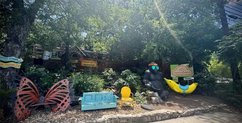 a sign that is sitting in front of flowers