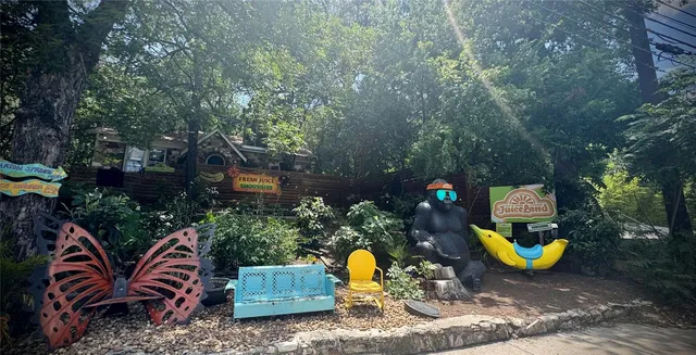 a sign that is sitting in front of flowers