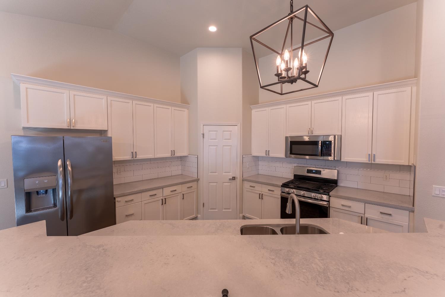 1963 Rialto Court Clovis, CA 93611 - Photo 14 of 36 a kitchen with stainless steel appliances a refrigerator and microwave