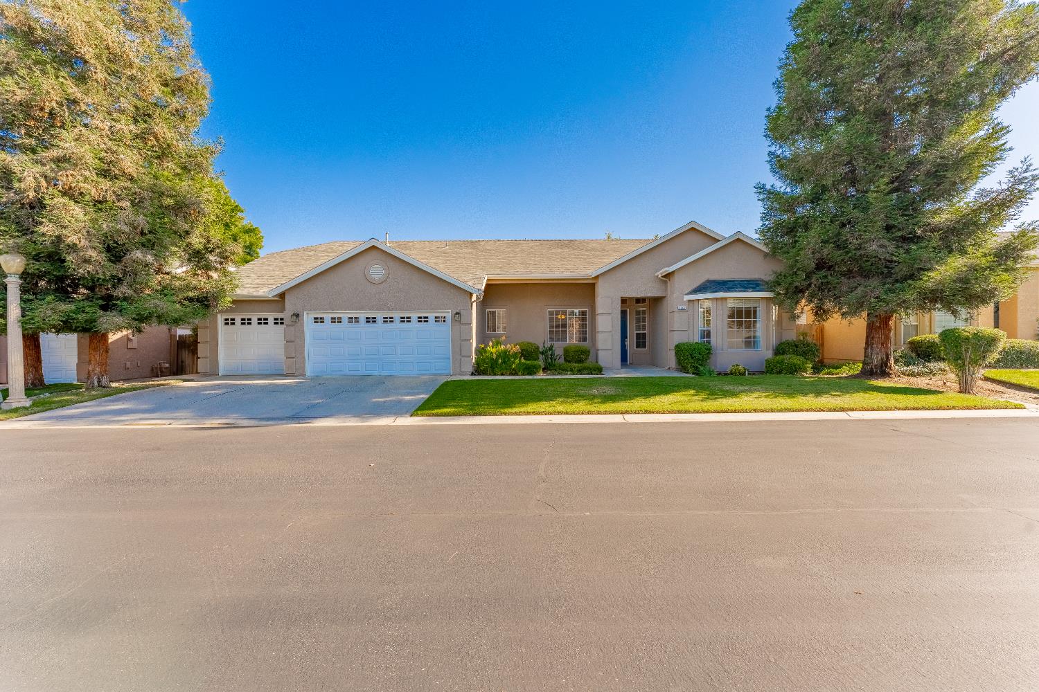 1963 Rialto Court Clovis, CA 93611 - Photo 2 of 36 a view of house with a big yard and large trees