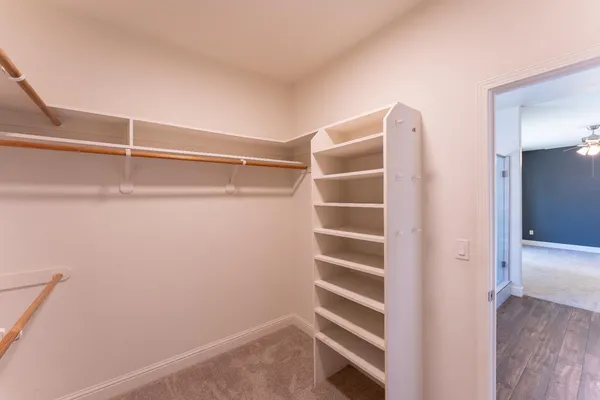 a view of walk in closet with empty racks