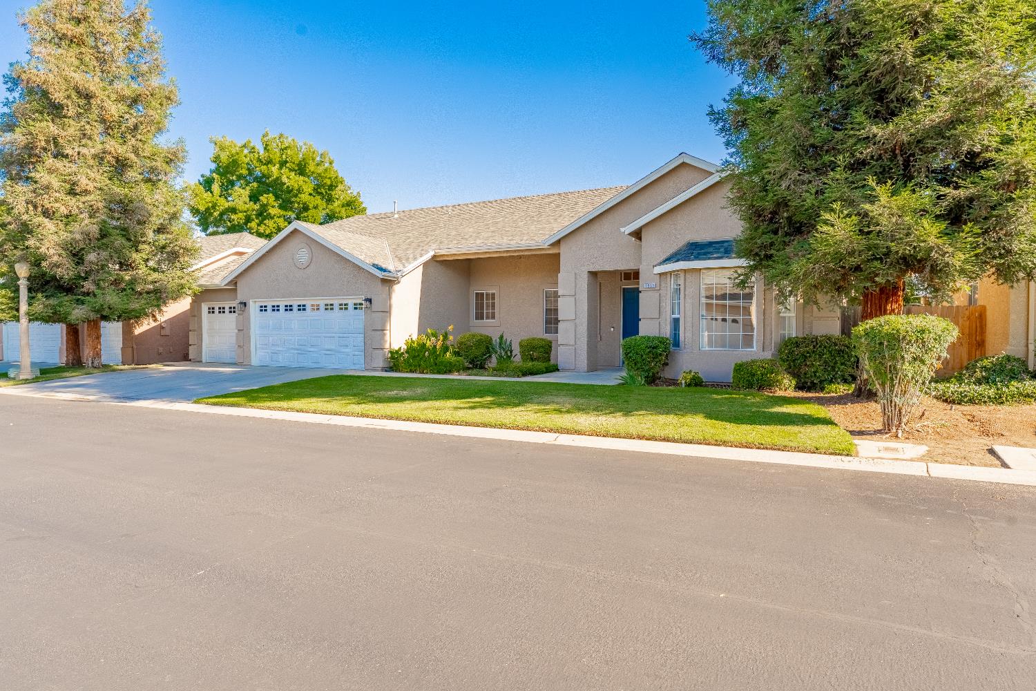 1963 Rialto Court Clovis, CA 93611 - Photo 3 of 36 a view of a house with a big yard and large trees