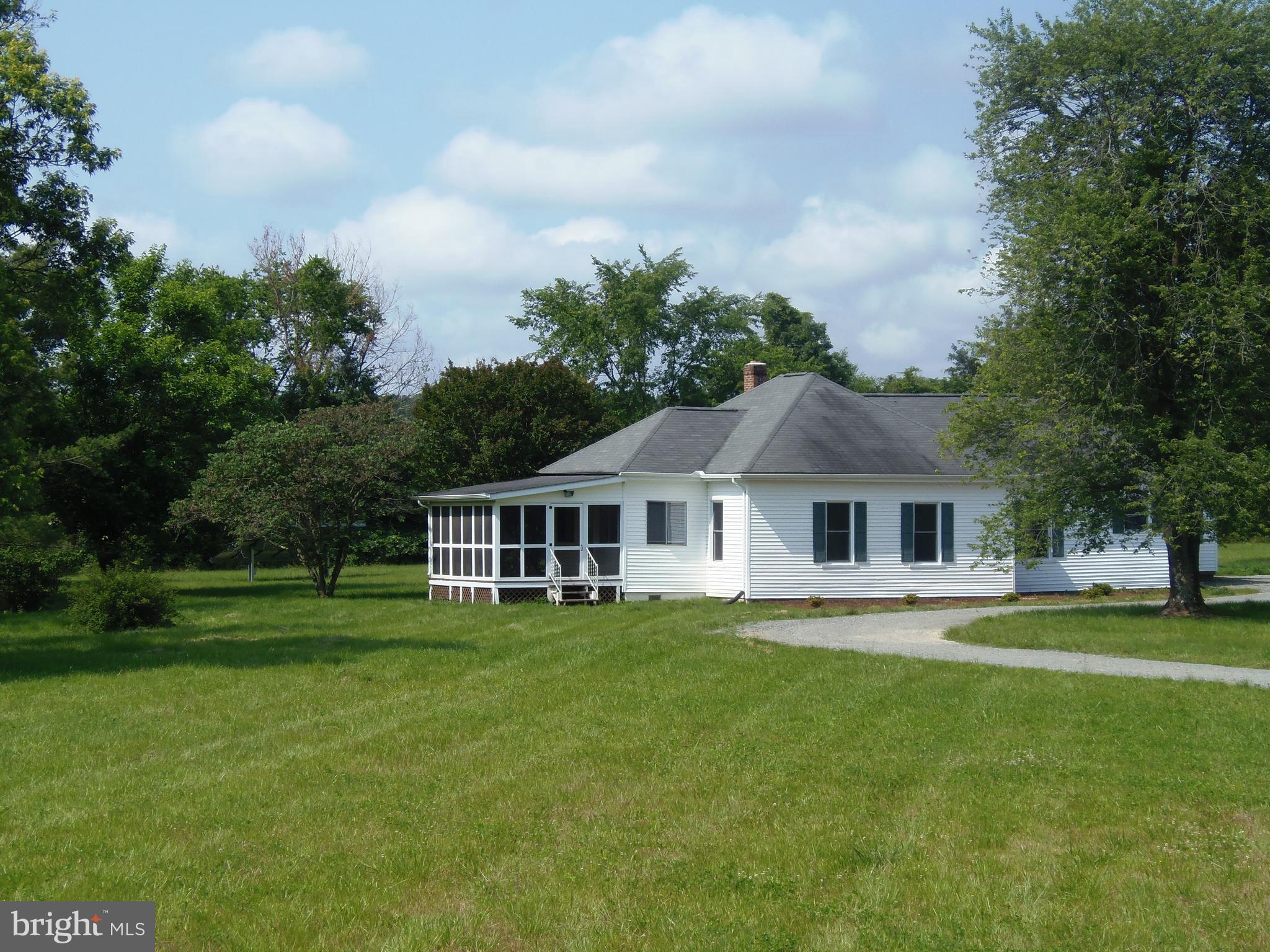 12058 Mitchell Road Mitchells, VA 22729 - Photo 2 of 38 a front view of a house with a garden