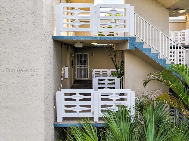 a living room with furniture and a lamp