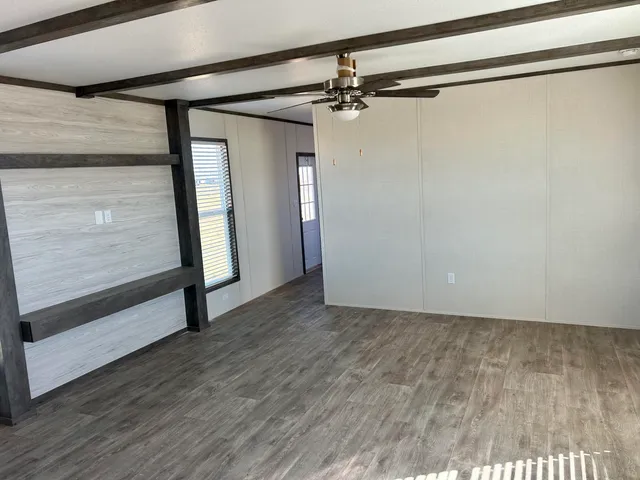 a view of a room with wooden floor
