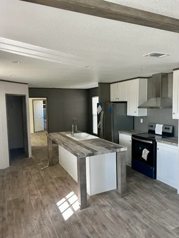 a kitchen with stainless steel appliances granite countertop a stove and a refrigerator