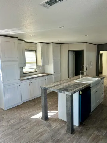 a kitchen with a sink and cabinets