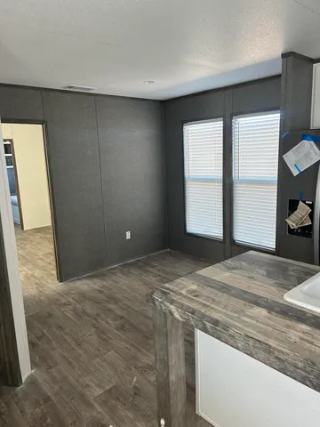 a view of empty room with closet and wooden floor