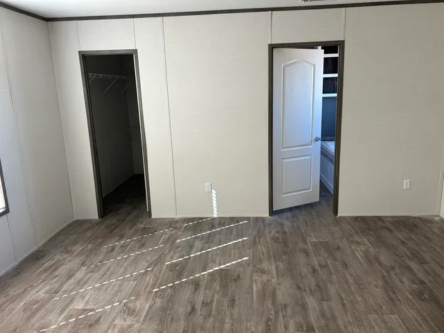a view of a closet area with wooden floor