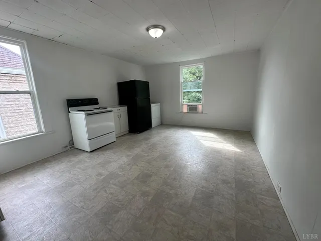 a kitchen with a refrigerator and window