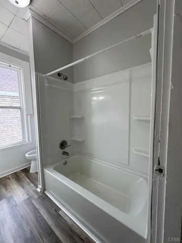 a white toilet sitting next to a small bathroom