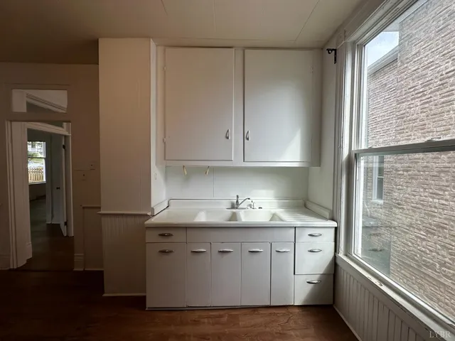 a kitchen with stainless steel appliances a sink a stove a refrigerator and cabinets