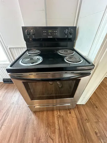 a stove top oven sitting inside of a kitchen