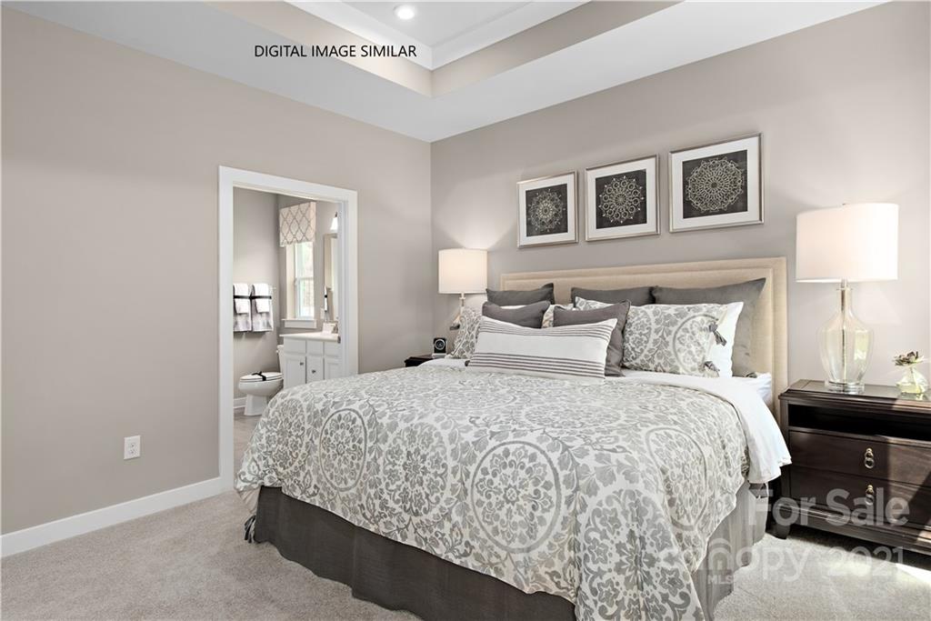 1619 Moore Farm Road, Unit 184 Indian Trail, NC 28079 - Photo 12 of 28 a bedroom with a bed and a night stand