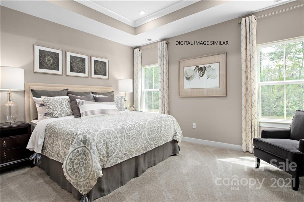 1619 Moore Farm Road, Unit 184 Indian Trail, NC 28079 - Photo 13 of 28 a bedroom with a bed and a couch next to a window