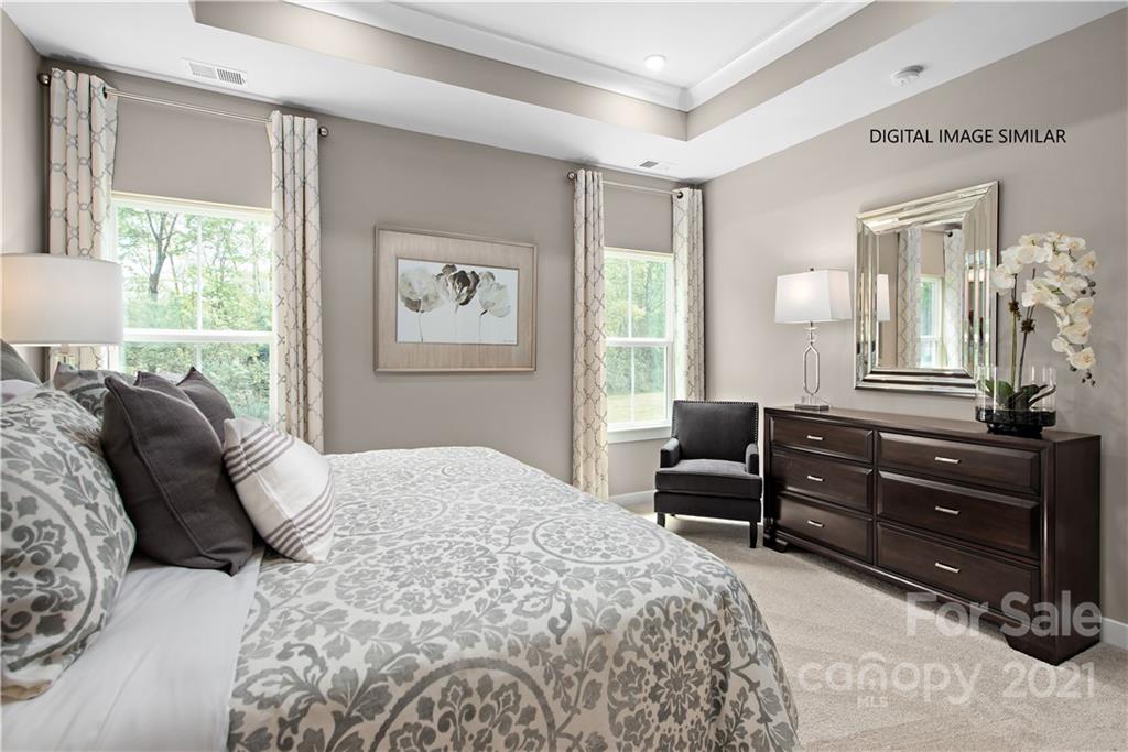 1619 Moore Farm Road, Unit 184 Indian Trail, NC 28079 - Photo 14 of 28 a bedroom with a bed and wooden floor
