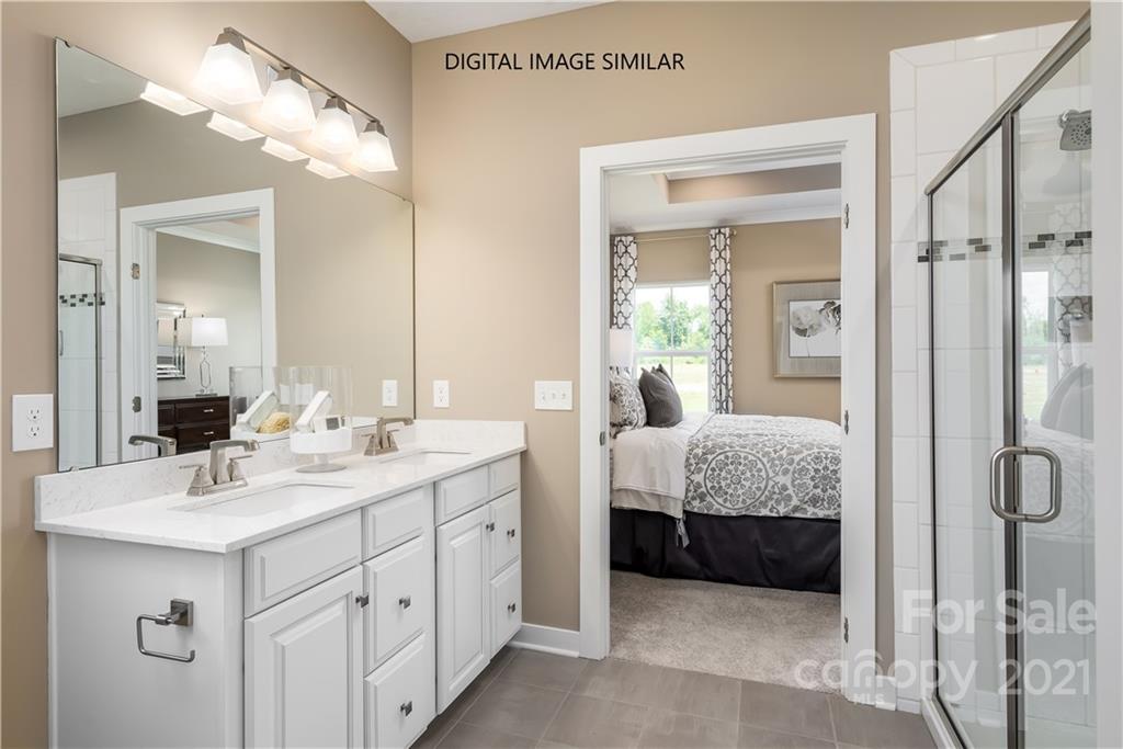 1619 Moore Farm Road, Unit 184 Indian Trail, NC 28079 - Photo 15 of 28 a en suite bathroom with double sink and a mirror