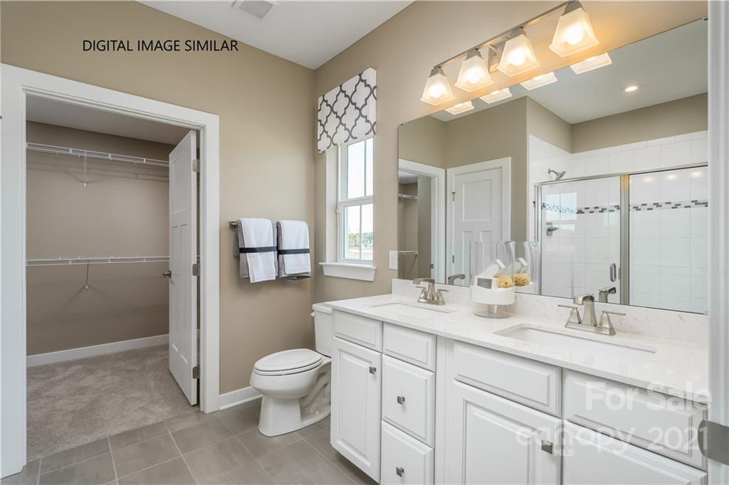 1619 Moore Farm Road, Unit 184 Indian Trail, NC 28079 - Photo 16 of 28 a bathroom with a double vanity sink mirror and toilet