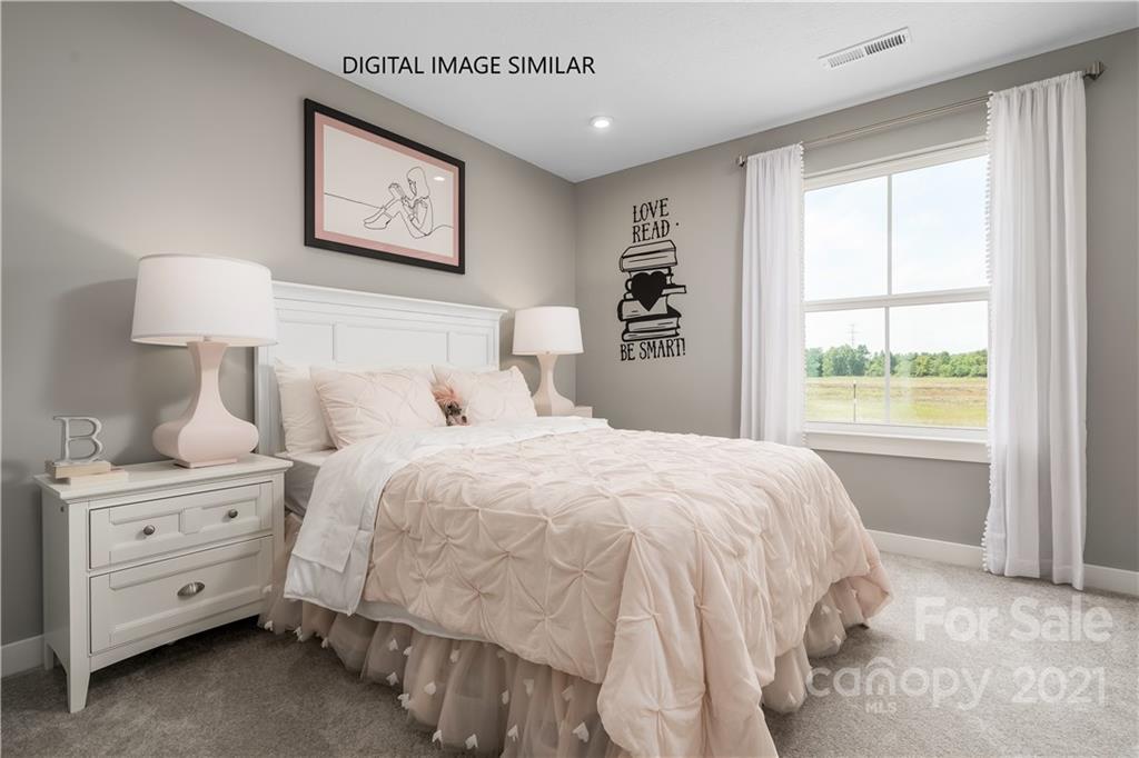 1619 Moore Farm Road, Unit 184 Indian Trail, NC 28079 - Photo 18 of 28 a bedroom with a bed and a window