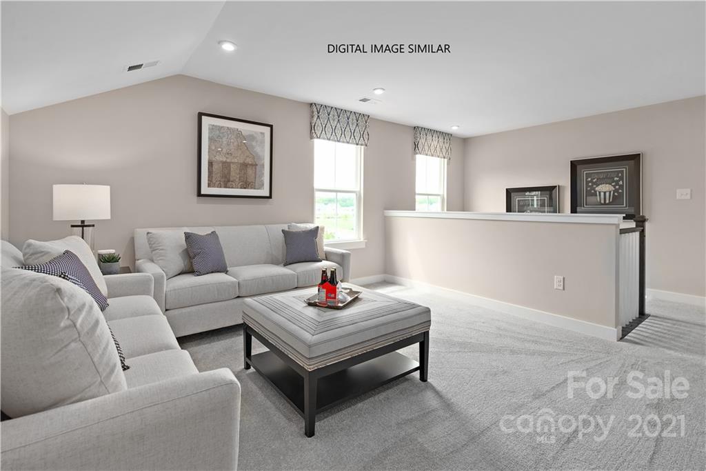 1619 Moore Farm Road, Unit 184 Indian Trail, NC 28079 - Photo 19 of 28 a living room with furniture and a wooden floor