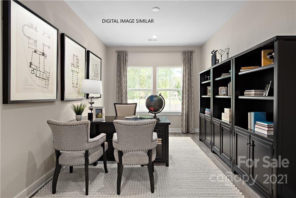 1619 Moore Farm Road, Unit 184 Indian Trail, NC 28079 - Photo 3 of 28 a dining room with furniture and a book shelf