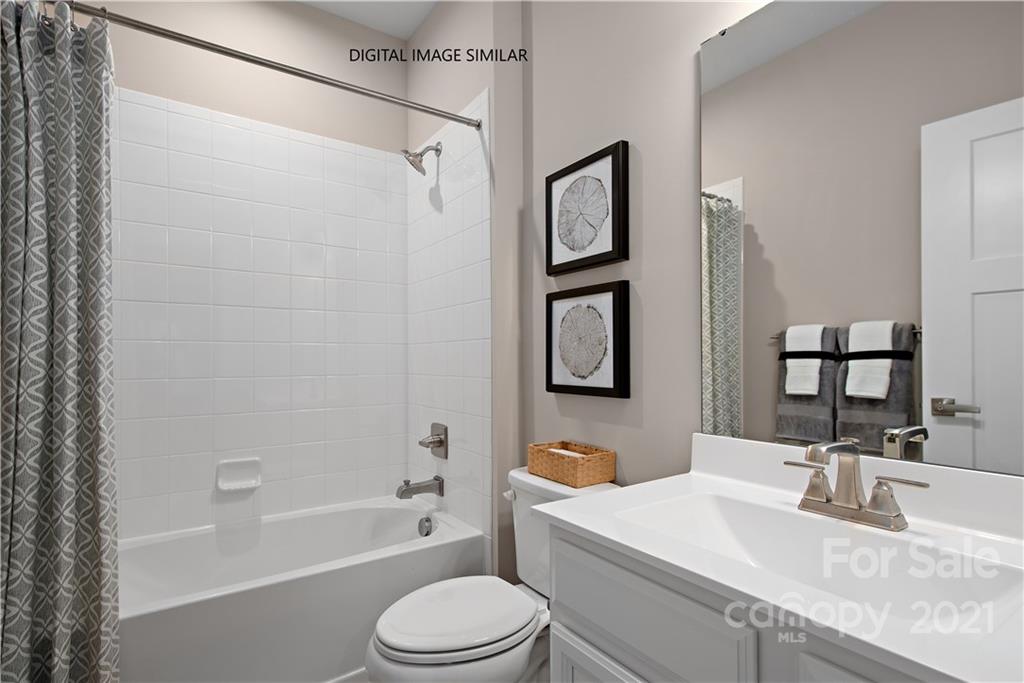 1619 Moore Farm Road, Unit 184 Indian Trail, NC 28079 - Photo 5 of 28 a bathroom with a granite countertop sink toilet and shower