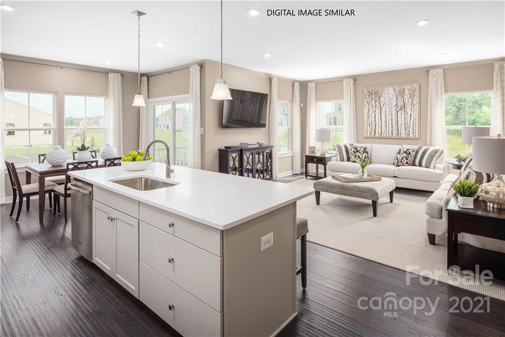 1619 Moore Farm Road, Unit 184 Indian Trail, NC 28079 - Photo 6 of 28 a open kitchen with stainless steel appliances kitchen island granite countertop a sink dishwasher a dining table and chairs with wooden floor