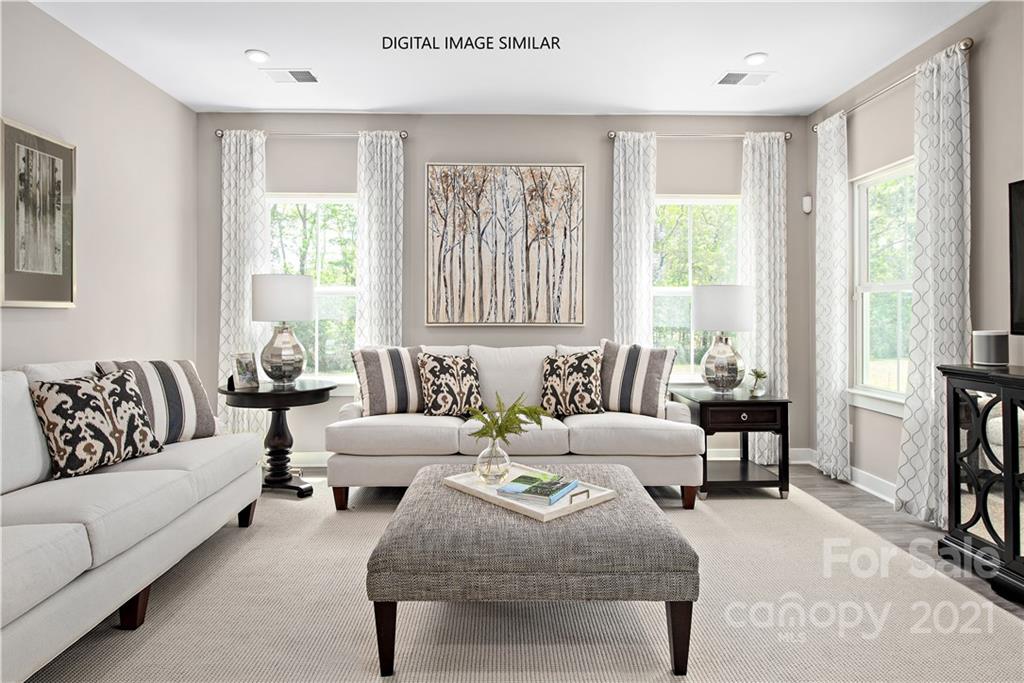 1619 Moore Farm Road, Unit 184 Indian Trail, NC 28079 - Photo 7 of 28 a living room with furniture and large windows