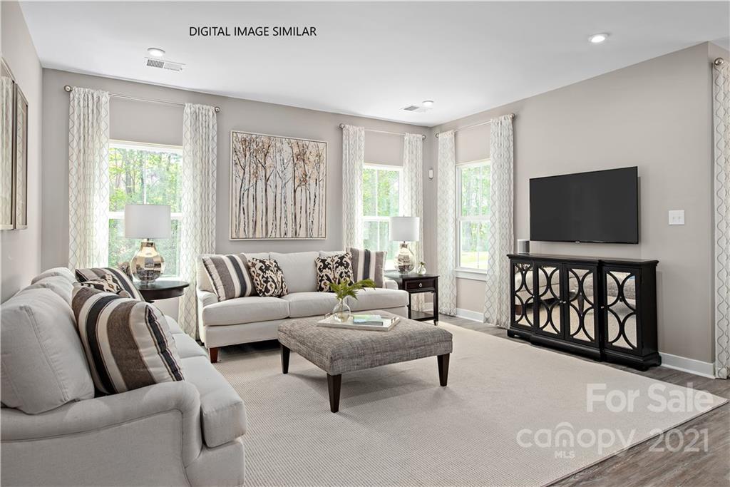 1619 Moore Farm Road, Unit 184 Indian Trail, NC 28079 - Photo 8 of 28 a living room with furniture and a flat screen tv