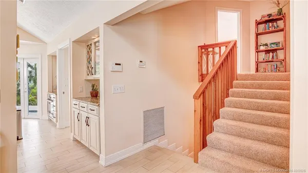 a view of an entryway with wooden floor and windows