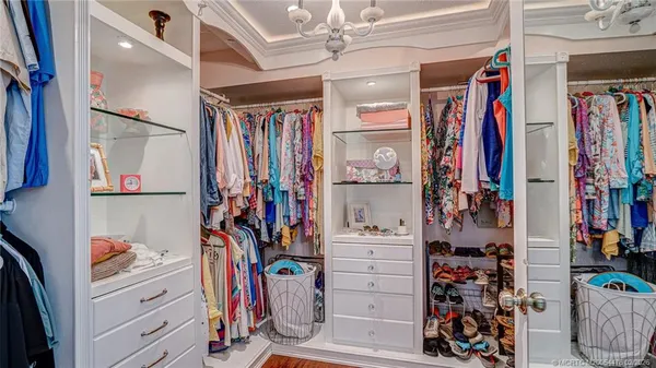 a view of walk in closet with clothes