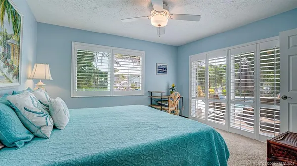 a spacious bedroom with a bed and a large window