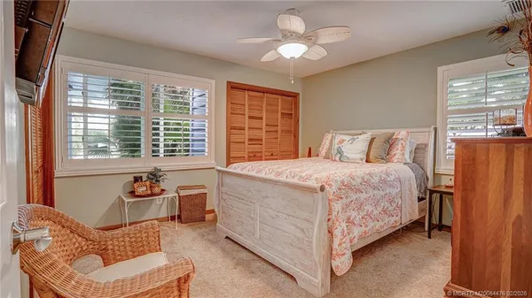 a spacious bedroom with a bed and a chandelier