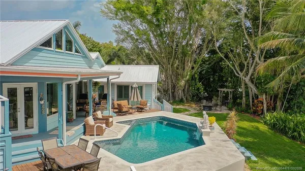 a view of a house with swimming pool and sitting area