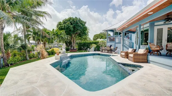 swimming pool view with a outdoor seating