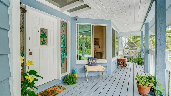 a balcony with furniture and wooden floor