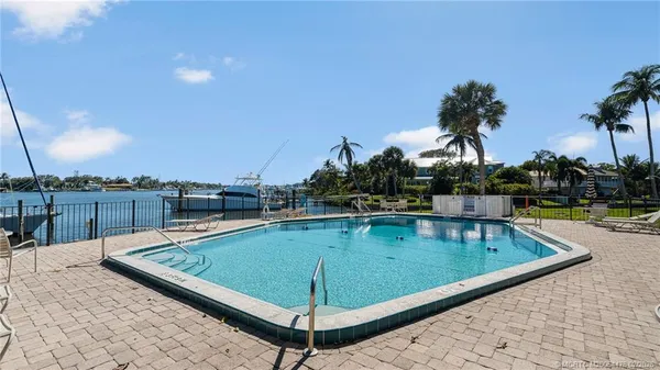 a view of a swimming pool with a lounge chairs