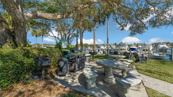 a view of a house with backyard water fountain and sitting area