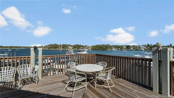 a view of a chairs and table on the roof deck