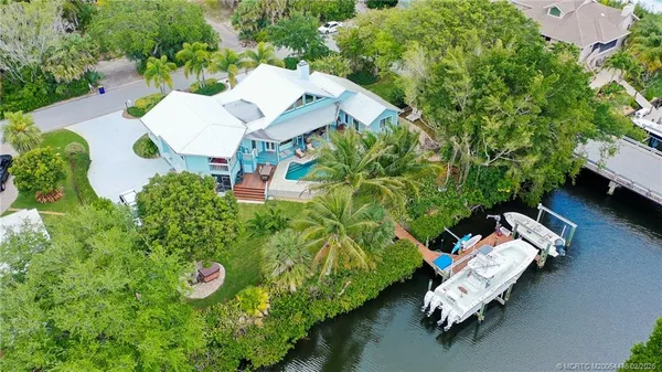 an aerial view of a house with garden space and street view