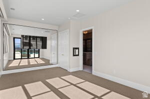 1141 East Lost Ridge Drive Washington, UT 84780 - Photo 80 of 108 Carpeted room featuring a mirrored wall and two white doors