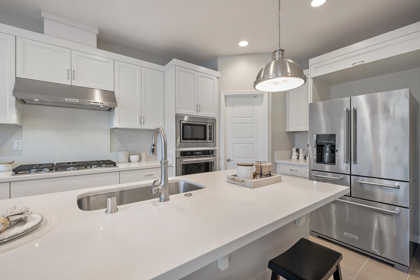 5010 Brook Valley Loop San Jose, CA 95136 - Photo 7 of 24 a kitchen with kitchen island a stove a sink and refrigerator