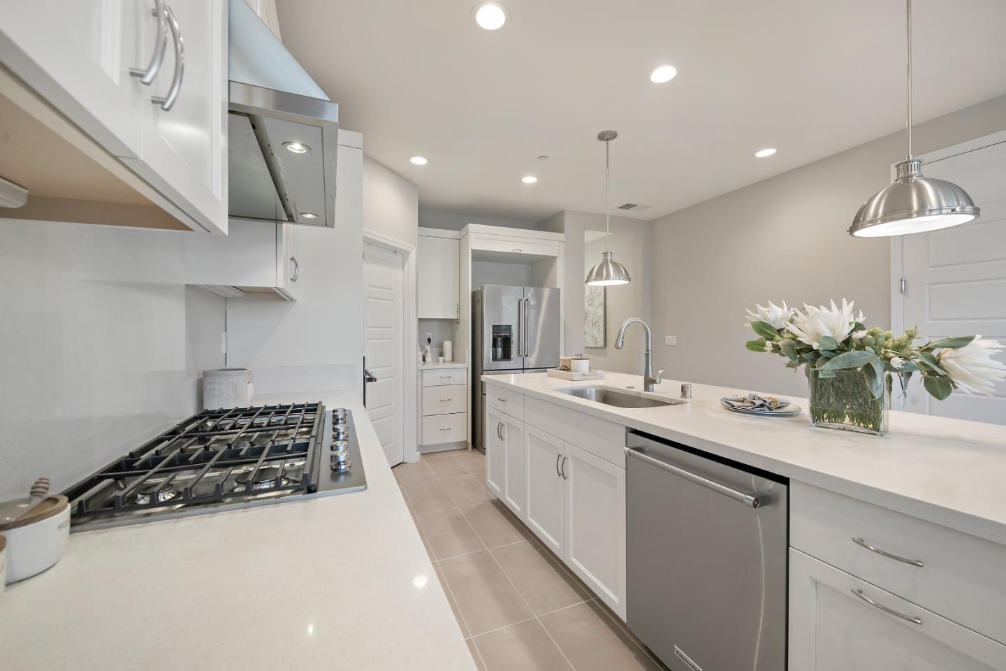 5010 Brook Valley Loop San Jose, CA 95136 - Photo 8 of 24 a kitchen with a sink stainless steel appliances and cabinets