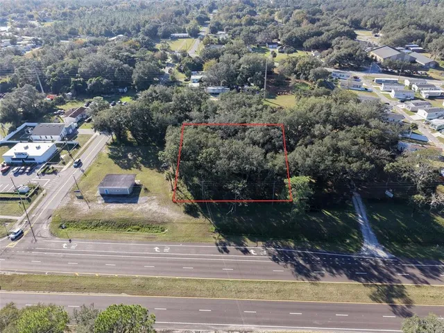 an aerial view of a house with a yard and garage