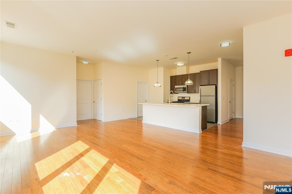 4 Main Street, Unit F Edgewater, NJ 07020 - Photo 6 of 20 a view of kitchen view with cabinets and wooden floor